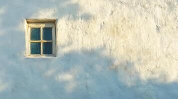 A Single Window on a White Wall with Shadowy Details photo