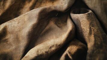 Close-up Texture of Brown Fabric with Wrinkles and Folds photo
