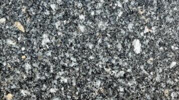Close-up of a Dark Gray Granite Surface with White and Yellow Specks photo