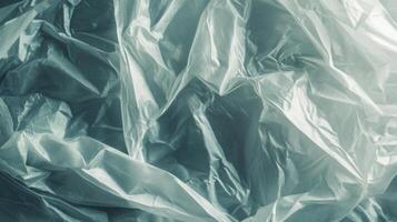Crinkled, translucent, white fabric with light reflecting off the surface. photo