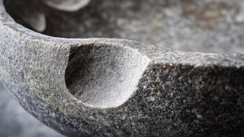 Close-up of a Rough Stone Mortar with a Deep Indentation photo