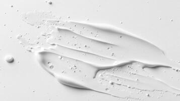 White Cream Swirl with Small Droplets on a Smooth Surface photo