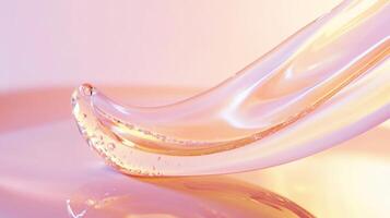 A Single Drop of Clear Gel on a Pink and Orange Gradient Background photo