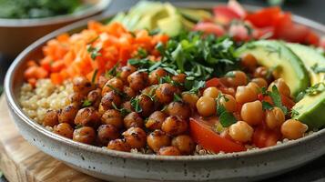 Beautifully plated vegan buddha bowl recipe featuring quinoa avocado slices roasted chickpeas and a colorful array of vegetables arranged in a harmonious pattern on a white plate photo