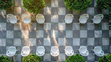 Top down view of outdoor event venue with rows of plastic chairs and a checkerboard seating arrangement white isolated background photo