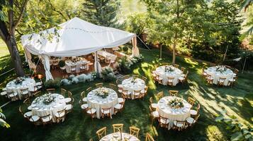 Top down view of elegant outdoor wedding reception with white tables and chairs under a large tent surrounded by nature white isolated background photo