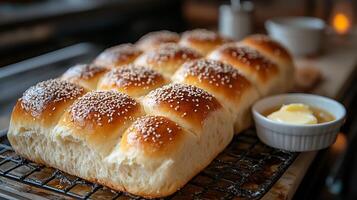 Soft fluffy bread rolls sesame seeds and melted butter baking photo