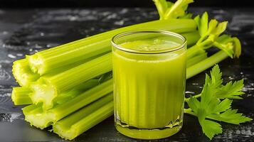 Glass of invigorating celery juice with celery stalks cut out on an isolated simple minimalist background photo