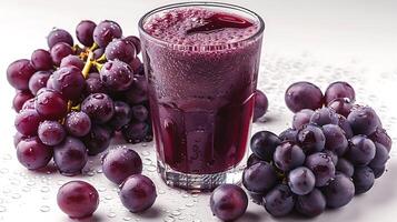 Glass of Tangy Grape Juice Grape Clusters A refreshing glass of grape juice enhanced by clusters of fresh grapes for a burst of flavor photo