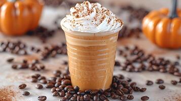 Cozy Pumpkin Spice Latte seasonal favorite topped with whipped cream and spice surrounded by coffee beans for added charm photo