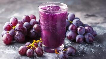 Glass of tangy grape juice with grape clusters cut out on an isolated simple minimalist background photo