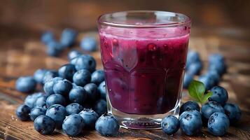 Glass of antioxidantrich blueberry juice with a handful of blueberries cut out on an isolated simple minimalist background photo