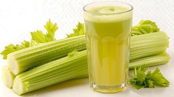Glass of invigorating celery juice with celery stalks cut out on an isolated simple minimalist background photo