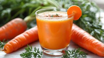 Glass of invigorating carrot juice with a carrot garnish cut out on an isolated simple minimalist background photo