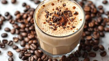 Frothy oat milk latte with a sprinkle of cocoa and surrounded by coffee beans all cut out on an isolated simple minimalist background photo