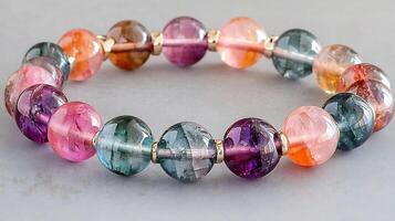 Charming fluorite and rhodochrosite bracelet with multicolored fluorite and pink rhodochrosite stones in a playful pattern photo