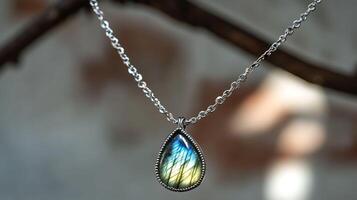 Mystical labradorite necklace with a shimmering bluegreen gemstone set in a delicate silver chain photo