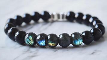Elegant obsidian and labradorite bracelet with deep black obsidian and shimmering bluegreen labradorite stones in a sleek design photo