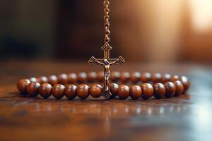Wooden rosary beads with crucifix resting on rustic tabletop photo