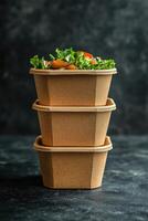 Stacked biodegradable cups with fresh salad inside them photo