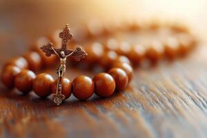 Wooden rosary beads with crucifix resting on rustic tabletop photo