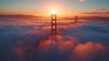 Golden gate bridge emerging from fog at sunrise photo