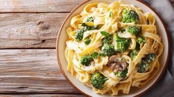 Creamy mushroom and broccoli pasta dish being served for dinner photo