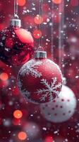 Christmas ornaments hanging on red background with falling snow photo