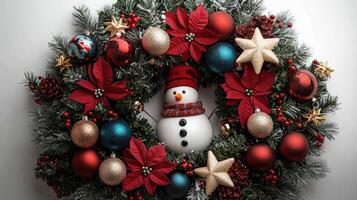 Christmas wreath with snowman, berries and baubles lying on white background photo
