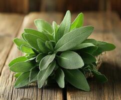 Fresh sage leaves tied together sitting on a rustic wooden table photo