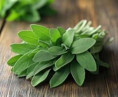 Fresh sage leaves tied together sitting on a rustic wooden table photo