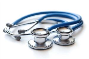 Blue stethoscope laying on white reflective surface with shallow depth of field photo
