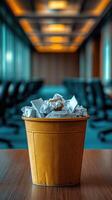 Trash can overflowing with paper in office building hallway photo