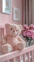 Teddy bear sitting on a cot in a pink bedroom for baby girl photo