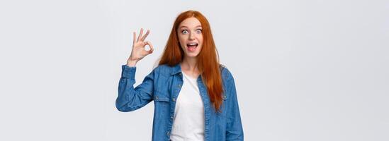 It was awesome. Ecstatic, excited and astonished redhead girl fan rate amazing concert, visited cool party, look imressed and astounded, smiling happy, make okay gesture, like or approve photo