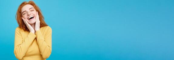 Lifestyle concept - Portrait of cheerful happy ginger red hair girl with joyful and exciting smiling to camera. Isolated on Blue Pastel Background. Copy space. photo