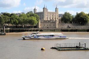 A view of the Tower of London across the river Thames in July 2021 on a sunny day photo