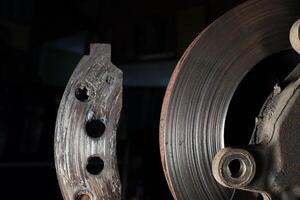 Brake pads expired.The car brake disc is broken.The car brake system is broken and needs to be repaired. photo