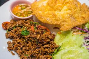 Stir Fried Beef with Holy Basil and Thai omelet.popula thailand streedfood photo