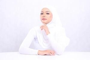 Beauty mature girl focus camera up hand touching chin with bright, glowing and smooth skin color. studio on isolated white background for skin care concept. beauty and health photo