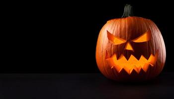 A pumpkin carved into a classic jack-o'-lantern with a menacing face, glowing brightly from within, set against a stark black background for dramatic effect. photo