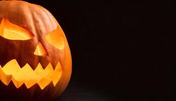 part of a pumpkin carved into a classic jack-o'-lantern with a menacing face, glowing brightly from within, set against a stark black background for dramatic effect. photo