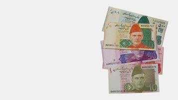 Pakistani currency bank notes aligned in sequence 10 20 50 100 500, Pakistan State Bank official currency notes 2024 isolated on a white background with copy space for text photo
