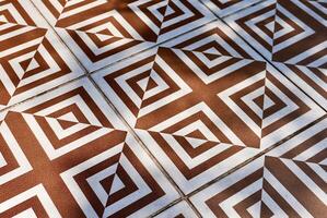 Abstract decorative brown and white floor tile pattern object isolated on horizontal ratio background. photo