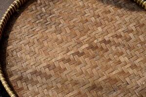 Bamboo or rattan brown round wooden tray object texture isolated on horizontal ratio background. photo