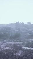 stones in snow on moutain in summer video