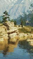 A picturesque mountain landscape with a flowing stream in the foreground video