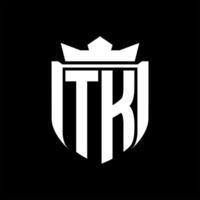 TK Letter logo shield shape inside shield badge crown on black background template design vector