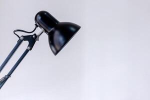 Black table lamp in a white background. Copy space. photo