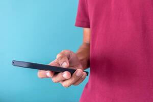 A man uses a mobile phone to search for information or use social media applications photo